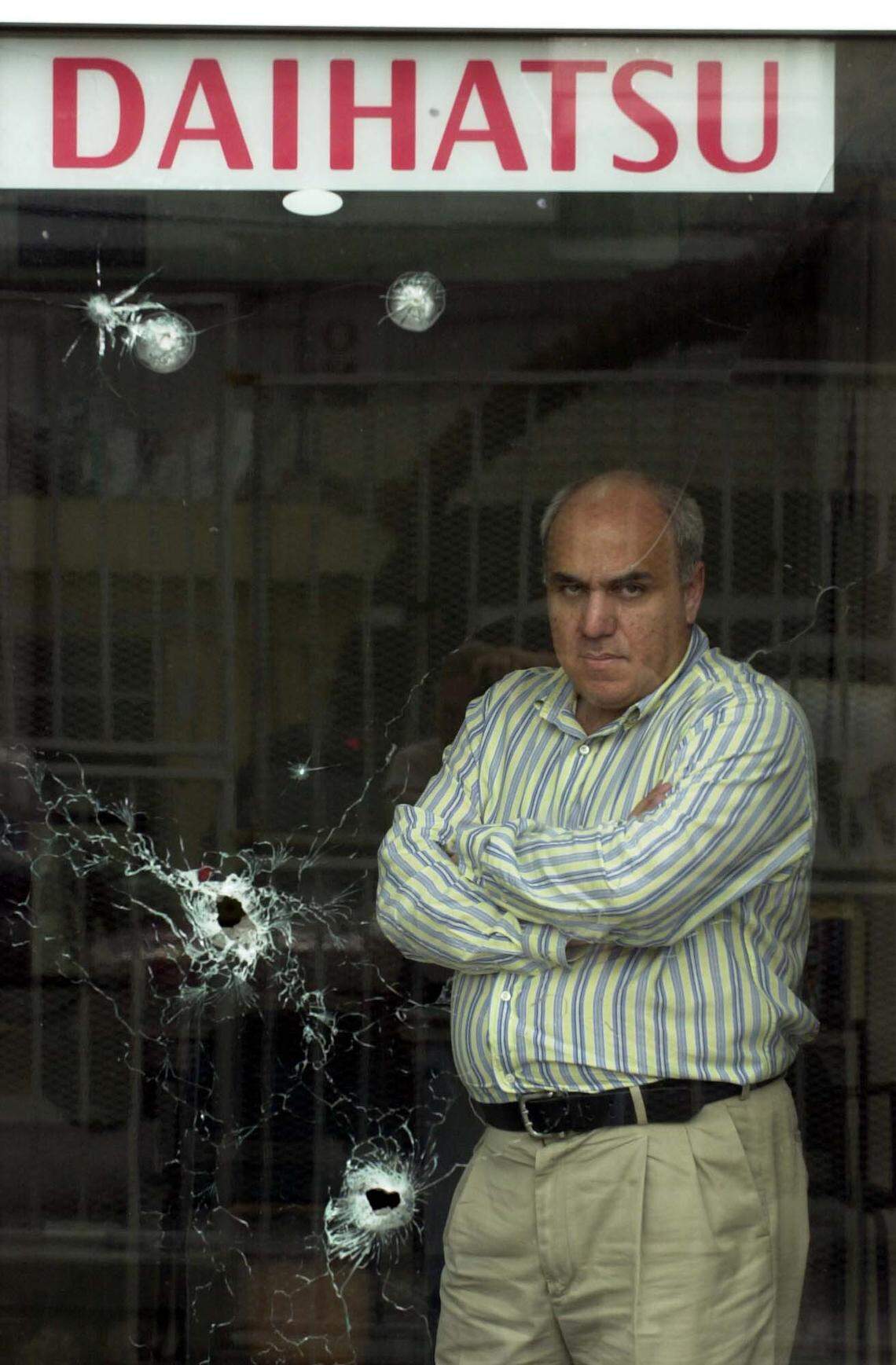 In a 2004 photo, Reginald Boulos president of Auto Plaza in Port-au-Prince, stood a a show room shot up during political turmoil In 2003, after his wife was kidnapped for a week, he moved his whole family to Miami, where he sometimes resided.