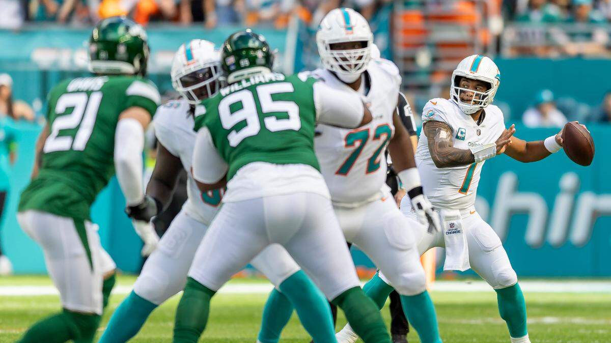 Miami Dolphins quarterback Tua Tagovailoa (1) looks to pass the ball in the first quarter of an NFL game against the New York Jets at Hard Rock Stadium on Sunday, Dec. 17, 2023, in Miami Gardens, Fla.
