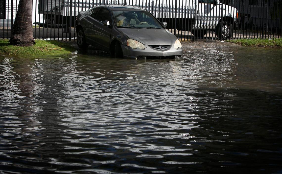 A parked car is partially submerged in a king tide flood in November in Miami. The city now routinely employs portable pumps to handle the higher tides, but some areas remain problematic.