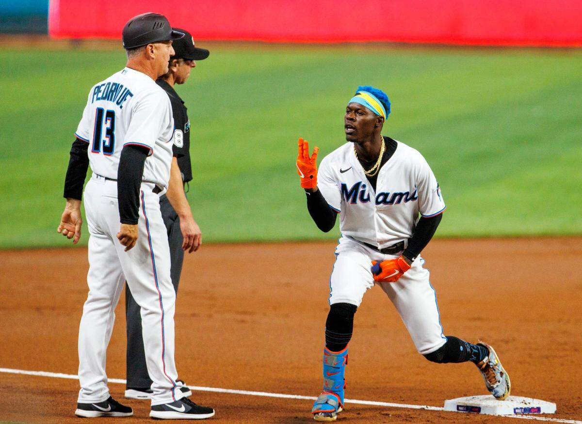 Miami Marlins second baseman Jazz Chisholm Jr. (2) reacts after hitting a triple during the first inning of a baseball game against the Washington Nationals at LoanDepot Park on Wednesday, May 18, 2022 in Miami, Florida..