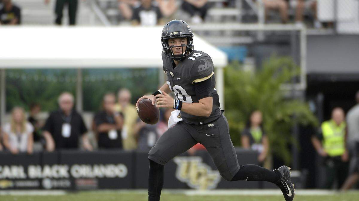 Central Florida quarterback McKenzie Milton (10) rolls out to throw a pass during the second half of an NCAA college football game against Navy Saturday, Nov. 10, 2018, in Orlando, Fla. UCF won 35-24.