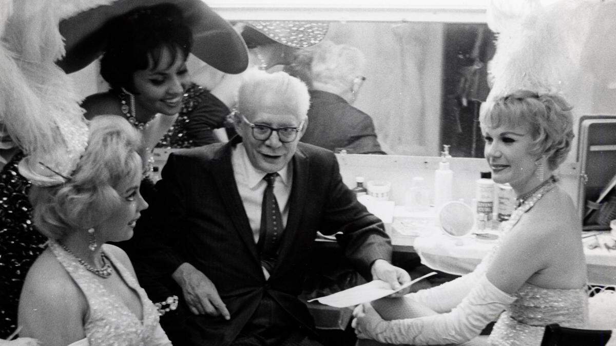 Lou Walters, owner of the Latin Club, with dancers.