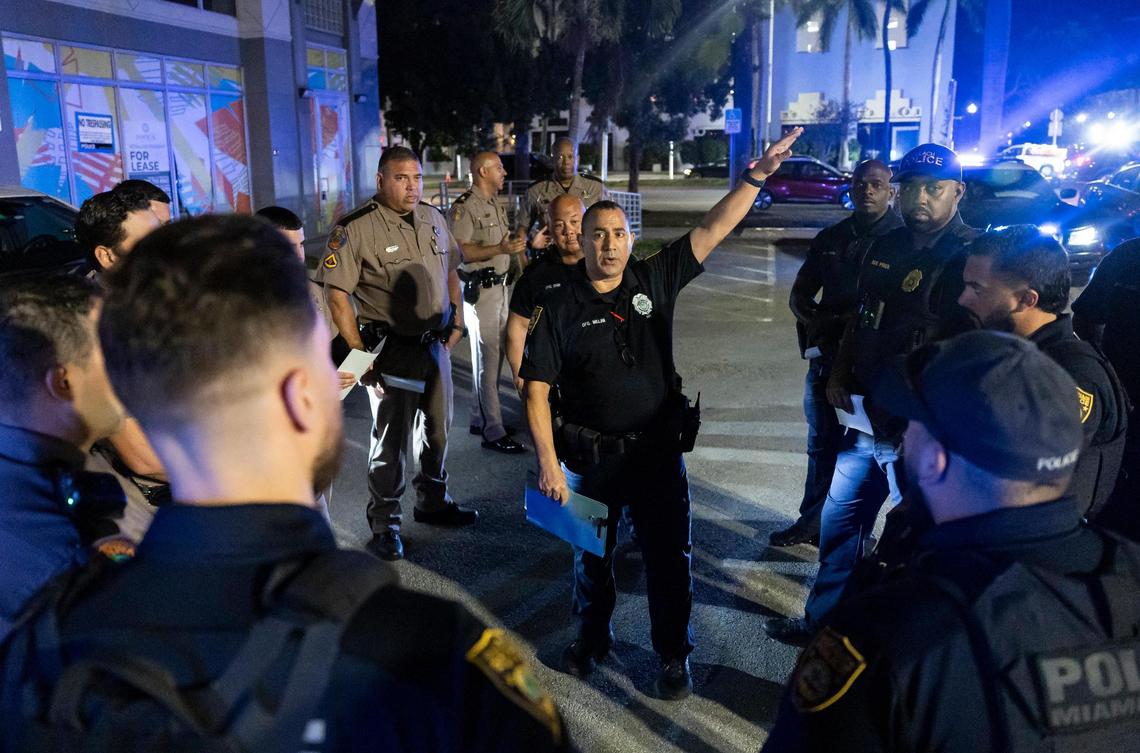 Miami Beach detective Kevin Millan holds a meeting with police officers as they prepare to implement a DUI checkpoint near 5th Street and Euclid Avenue during spring break on Friday, March 14, 2025, in Miami Beach, Fla.