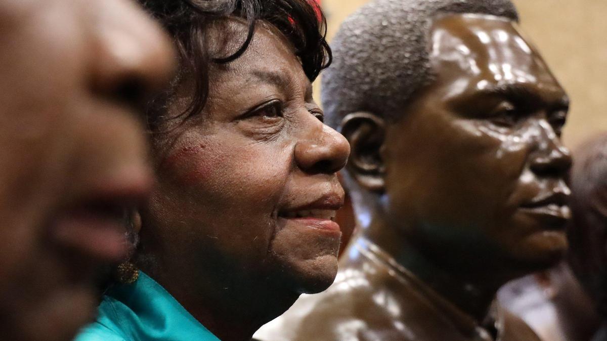 Miami historian Dorothy Fields stands next to the bust of her late uncle, the Honorable John D. Johnson, the second black judge in Miami and the fourth in Florida, after it was unveiled Tuesday, Feb. 18, 2020, at the Dade County Courthouse. The Miami office of Hunton Andrews Kurth commissioned the bust.