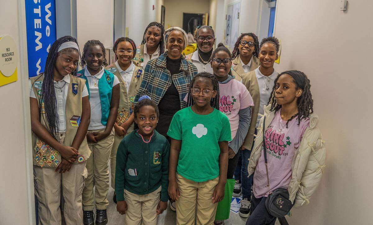 Miami Gardens Girl Scout leader Janice Coakley (center) posed with a group of Girl Scouts members of her rToop 347, during a meeting at the Betty T. Ferguson Recreational Complex, in Miami Gardens on Tuesday, January 28, 2026.