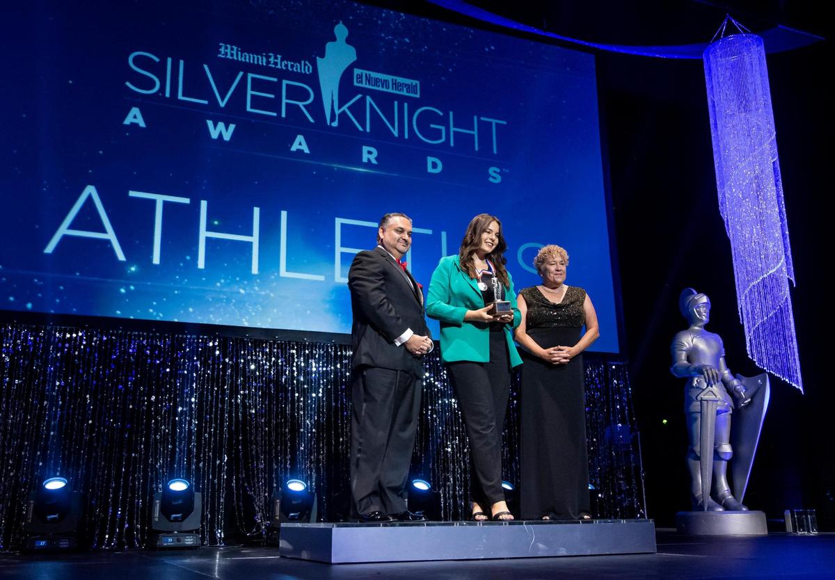 Silver Knight winner Samantha Martin, from Miami Beach Senior High School, is photographed with Alex Mena, Interim Executive Editor of the Miami Herald & el Nuevo Herald, and Dana Banker, Senior Managing Editor of the Miami Herald, after winning in the Athletics category during the Miami Herald & el Nuevo Herald 65th Silver Knight Award Ceremony at the James L. Knight Center on Thursday, May 25, 2023, in downtown Miami, Fla.