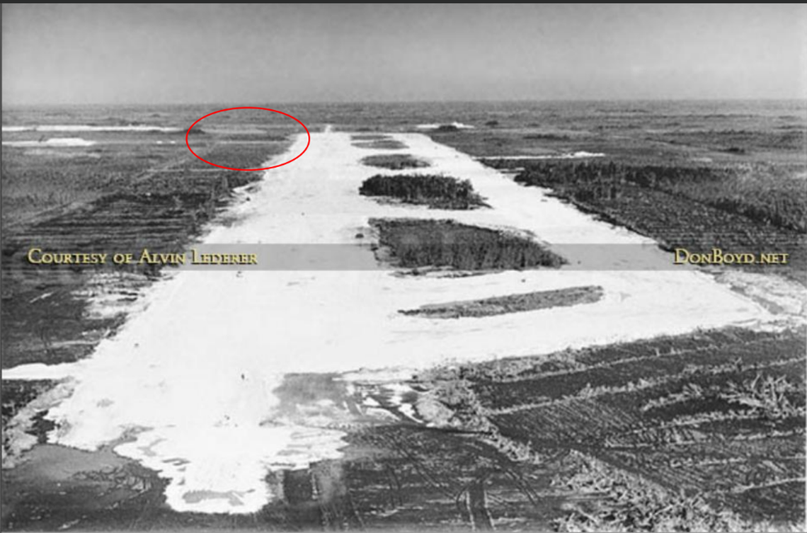 An aerial view of the Dade County Training & Transition Airport from 1970, when it was under construction, with the area of new asphalt in 2025 circled in red.