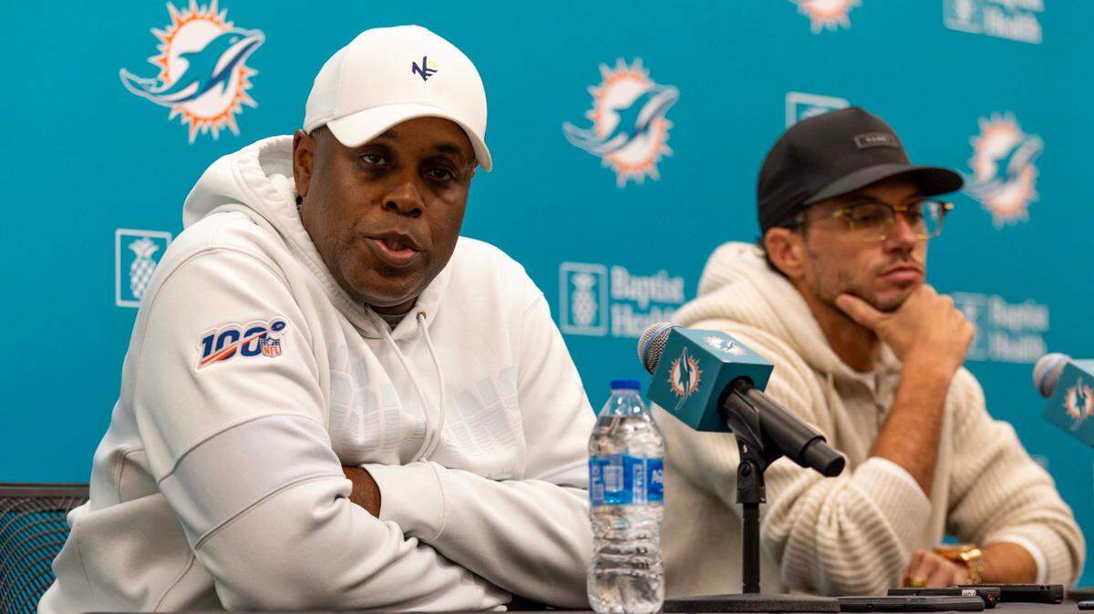 Miami Dolphins General Manager Chris Grier (left) speaks to the media as Head Coach Mike McDaniel looks on during an end-of year press conference at the Baptist Health Training Complex on Tuesday, January 7, 2025, in Miami, Fla.