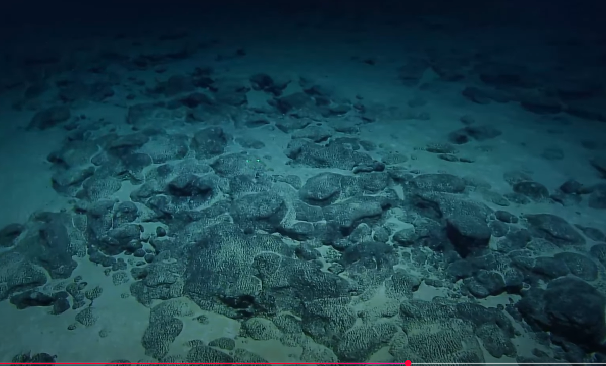 The volcano eruption that formed the seafloor rocks dates back 75 million to 90 million years, experts say. However, the glow came later, as sediments settled on the rocks and hardened over time, scientists say.