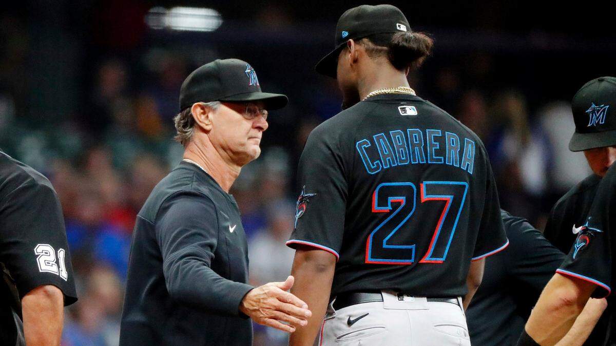 Miami Marlins starting pitcher Edward is consoled by manager Don Mattingly as he leaves the game following an injury during the fourth inning of a baseball game against the Milwaukee Brewers, Saturday, Oct. 1, 2022, in Milwaukee. (AP Photo/Jon Durr)