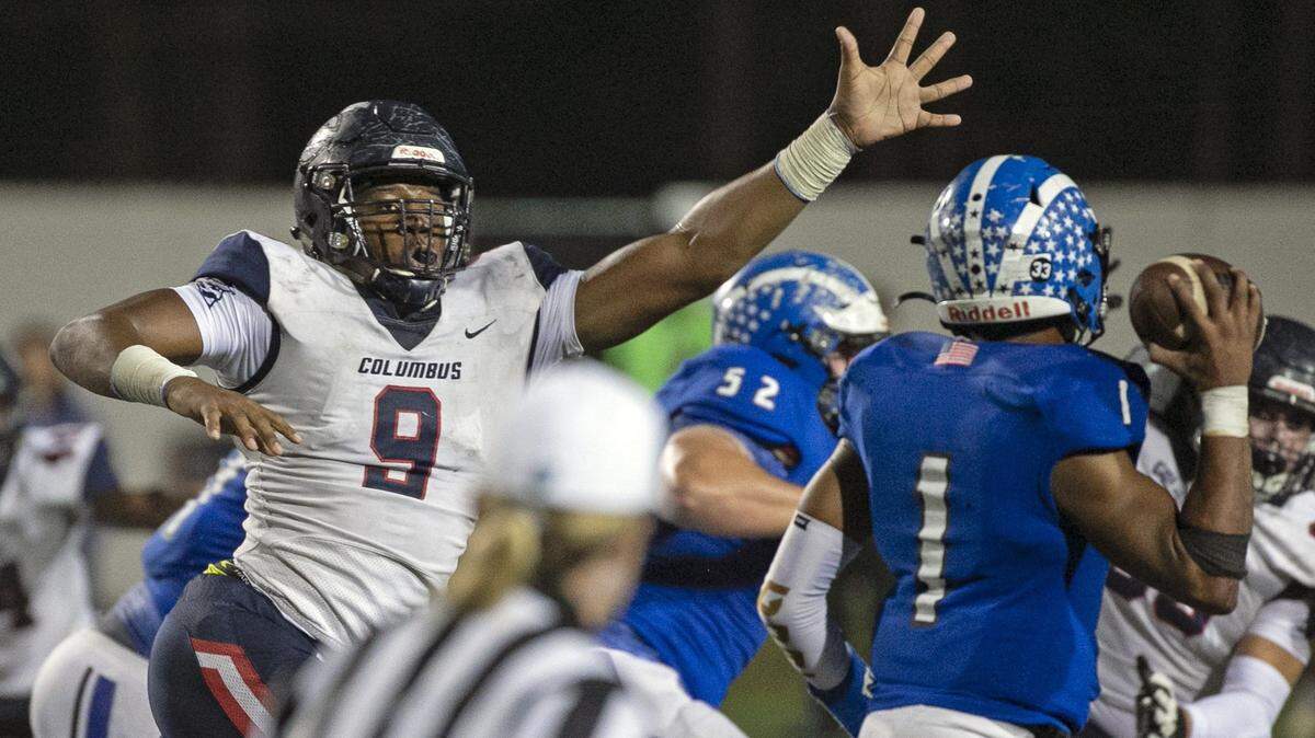 The Explorers Elijah Roberts puts pressure on Apopka’s quarterback Jaquan Lowman in the second quarter as the Columbus Explorers play Apopka for the Class 8A FHSAA State Championship at Daytona Stadium in Daytona Beach on Friday, December 13, 2019.