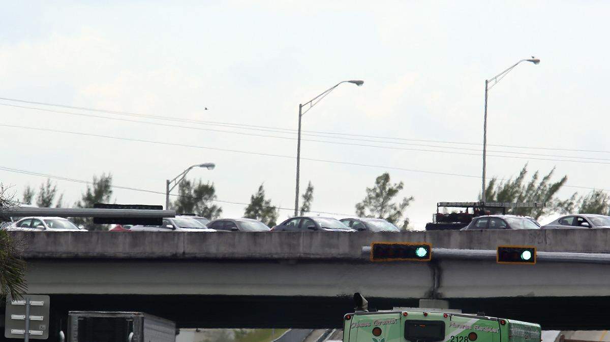 On the bridge across center of photo, northbound Interstate 95 traffic at Miami Gardens Drive in north Miami-Dade County appears at a standstill on Friday afternoon, Oct. 9, 2015. Portions of I-95 were shut down after Florida Highway Patrol troopers at a crash scene spotted what turned out to be a fake grenade in one of the vehicles. The crash was on the east side of I-95, north of Miami Gardens Drive.
