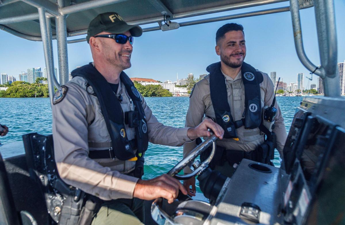 FWC officers Tyler Dunn and George Reynaud, navigated on the Watson Island anchorage area in Miami, during a press event held by the Florida Fish and Wildlife Conservation Commission, along with the city of Miami and Miami-Dade County police departments, to announce a combined effort underway this week to document both derelict vessels in South Florida, and those at risk of becoming derelict, on Tuesday, October 17, 2023.