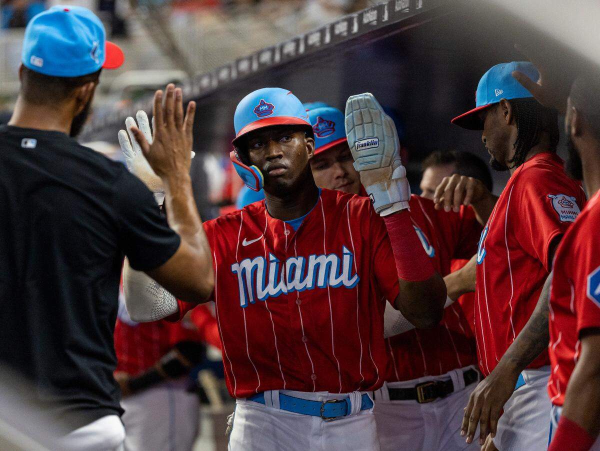 Miami Marlins right fielder Jesus Sanchez (7) celebrates with his teammates after scoring a run against the Chicago Cubs in the first inning of an MLB game at loanDepot park on Saturday, April 29, 2023, in Miami, Fla.