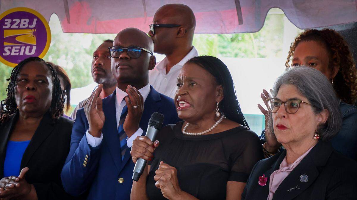 Miami-Dade Commissioner Marleine Bastien, center, demands the reinstatement of TPS for Haitians along with Commissioner Kionne L. McGhee, left, and Miami-Dade Mayor Daniella Levine Cava during a community vigil in Little Haiti. FANM ( Family Action Network Movement) hosted a community vigil on Monday, Jan. 12, to mark the 16th anniversary of Haiti's devastating 2010 earthquake with a moment of silence at 4:53 pm in remembrance of those who lost their lives and in support of continued TPS for Haitians at the Toussaint Louverture Memorial Statue where featured remarks from community leaders, local politicians, impacted parties and advocates gathered prior to the procession to the Little Haiti Cultural Complex on Monday, January 12, 2026, in Miami, Florida.