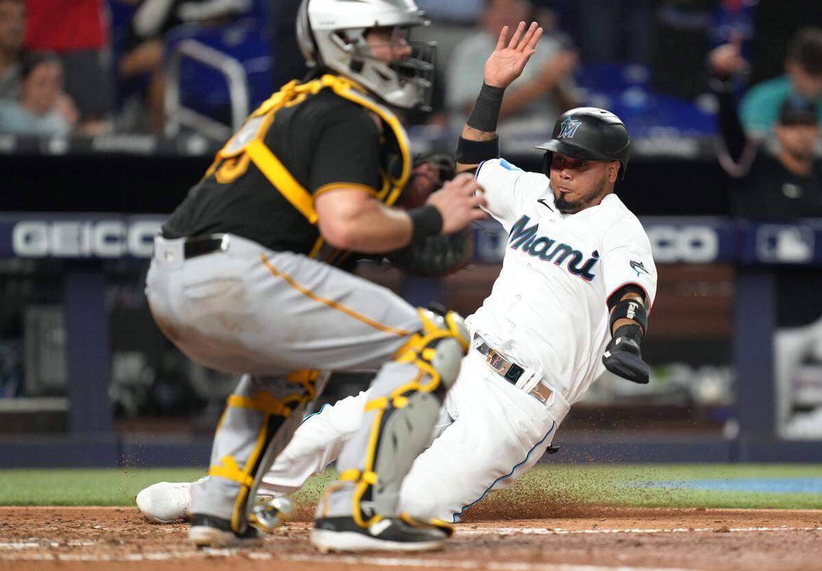 Jun 22, 2023; Miami, Florida, USA; Miami Marlins second baseman Luis Arraez (3) scores a run in the eighth inning against the Pittsburgh Pirates at loanDepot Park. Mandatory Credit: Jim Rassol-USA TODAY Sports