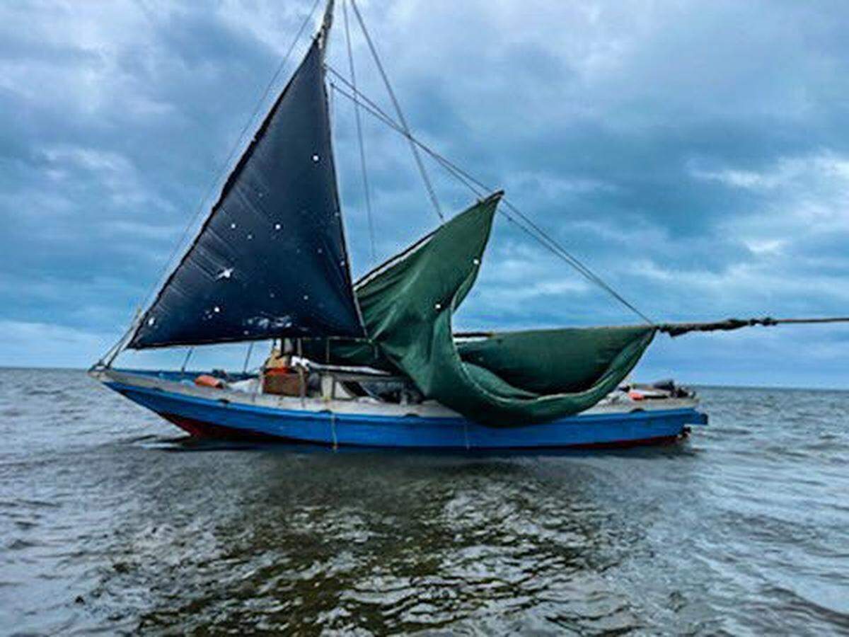 A sailboat floats in the shallow water off Card Sound Road in Key Largo Wednesday, Nov. 17, 2021. The U.S. Border Patrol said 61 migrants from Haiti were on the vessel. Another large group of migrants arrived Sunday night, Jan. 9, 2022, in almost the same area.