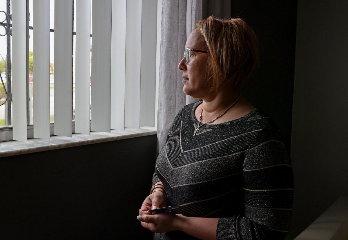 Yudet Pérez, a tenant of an apartment building located at 1501 W 42nd St. in Hialeah, looks through the window of her unit on Wednesday, Jan. 12, 2022. Her new landlord increased the rent of her two-bedroom unit from $1,050 to $1,650, a 55% increase. The landlord then filed a lawsuit to evict her and her family.