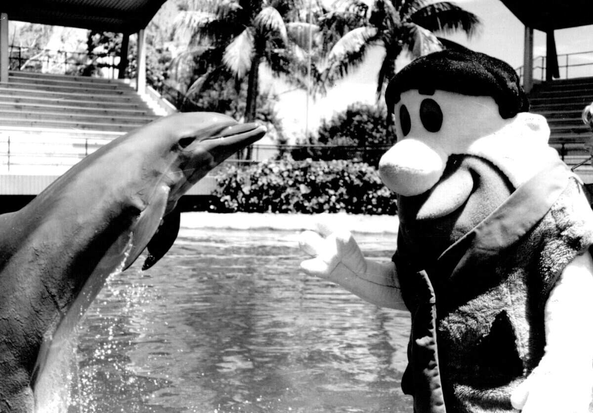 Fred Flintstone meets Flipper at the Seaquarium.