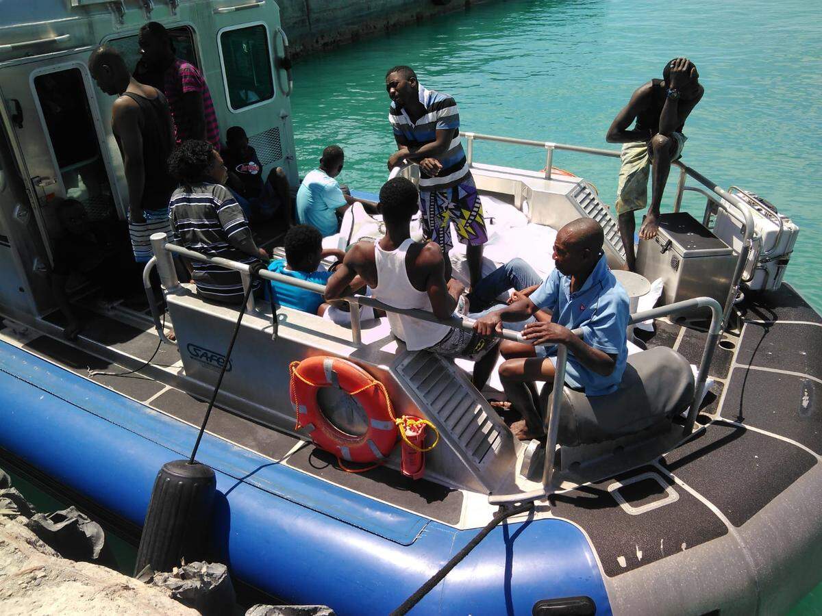 The Royal Turks and Caicos Police force rescued 14 Haitians on Sunday after their boat capsized off the coast of West Caicos.