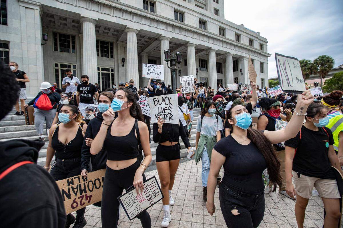 Protesters march to Miami-Dade County Courthouse on Flagler Street in downtown Miami on Friday, June 12, 2020.