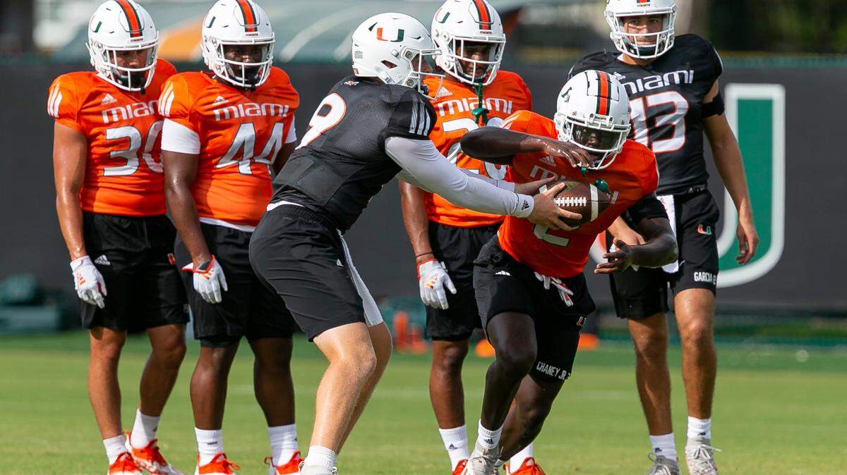 Miami Hurricanes quarterback Tyler Van Dyke (9) passes the ball to running back Donald Chaney, Jr., (2) as they run drills at the University of Miami’s Greentree Practice Fields on Monday, Aug. 8, 2022, in Coral Gables, Fla.