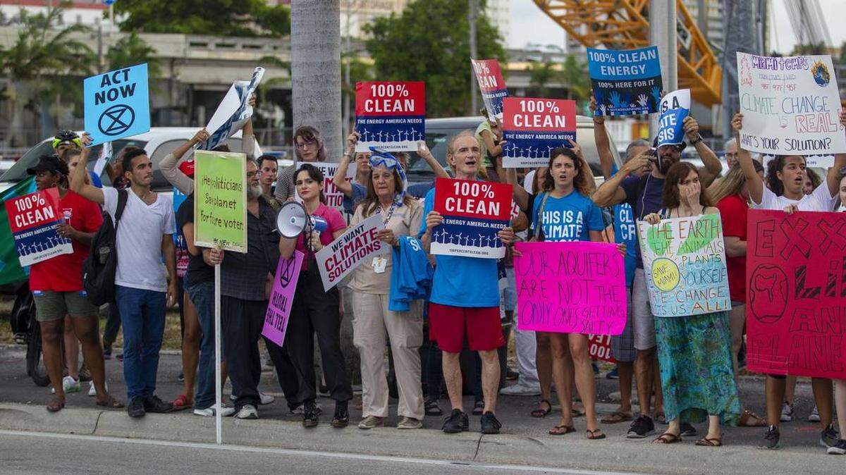 Protesters outside the Adrienne Arsht Center in Miami, advocate for stricter environmental laws before the Democratic candidates’ debate in June 2019.