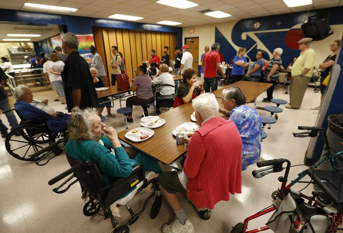 People at a Red Cross shelter set up at North Miami Beach Senior High School eat lunch, Friday, Sept. 8, 2017 before Irma made landfall in Florida.