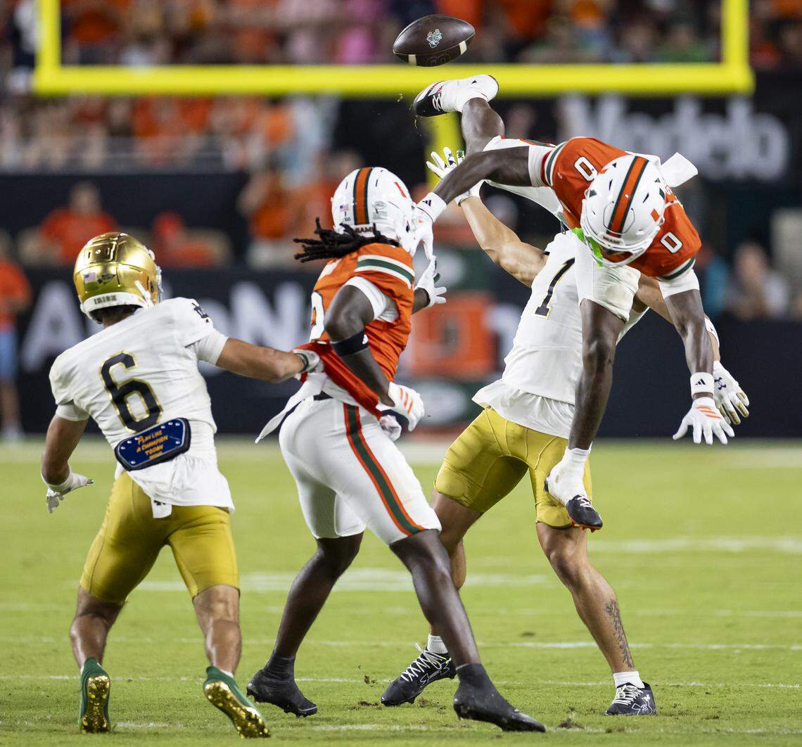 Miami Hurricanes defensive back Keionte Scott (0) deflects a pass intended for Notre Dame Fighting Irish wide receiver Jaden Greathouse (1) in the second half of their NCAA football game at Hard Rock Stadium on Sunday, Aug. 31, 2025, in Miami Gardens, Fla.