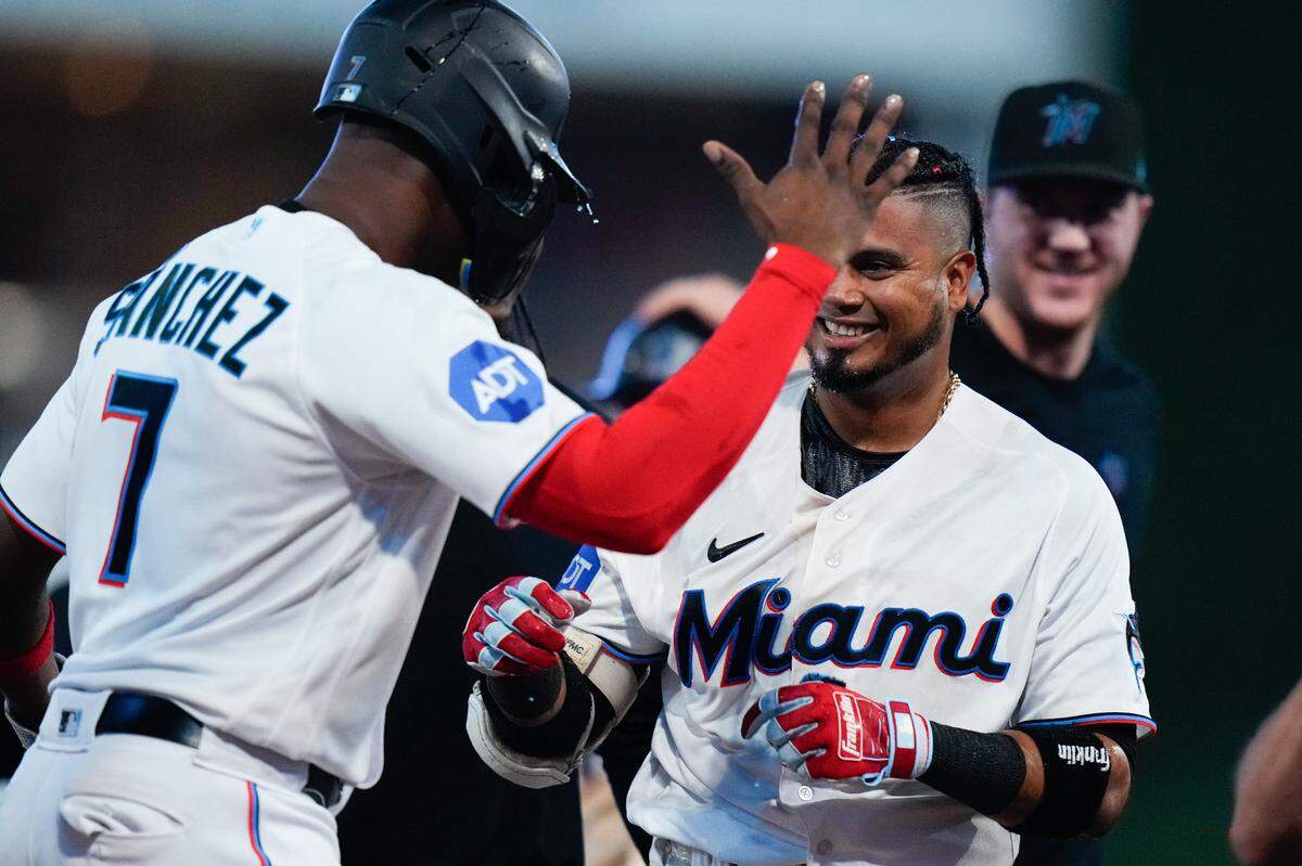 Miami Marlins second baseman Luis Arraez (3) celebrates with team mate after hitting the winning hit against the Colorado Rockies during the tenth inning at loanDepot Park.