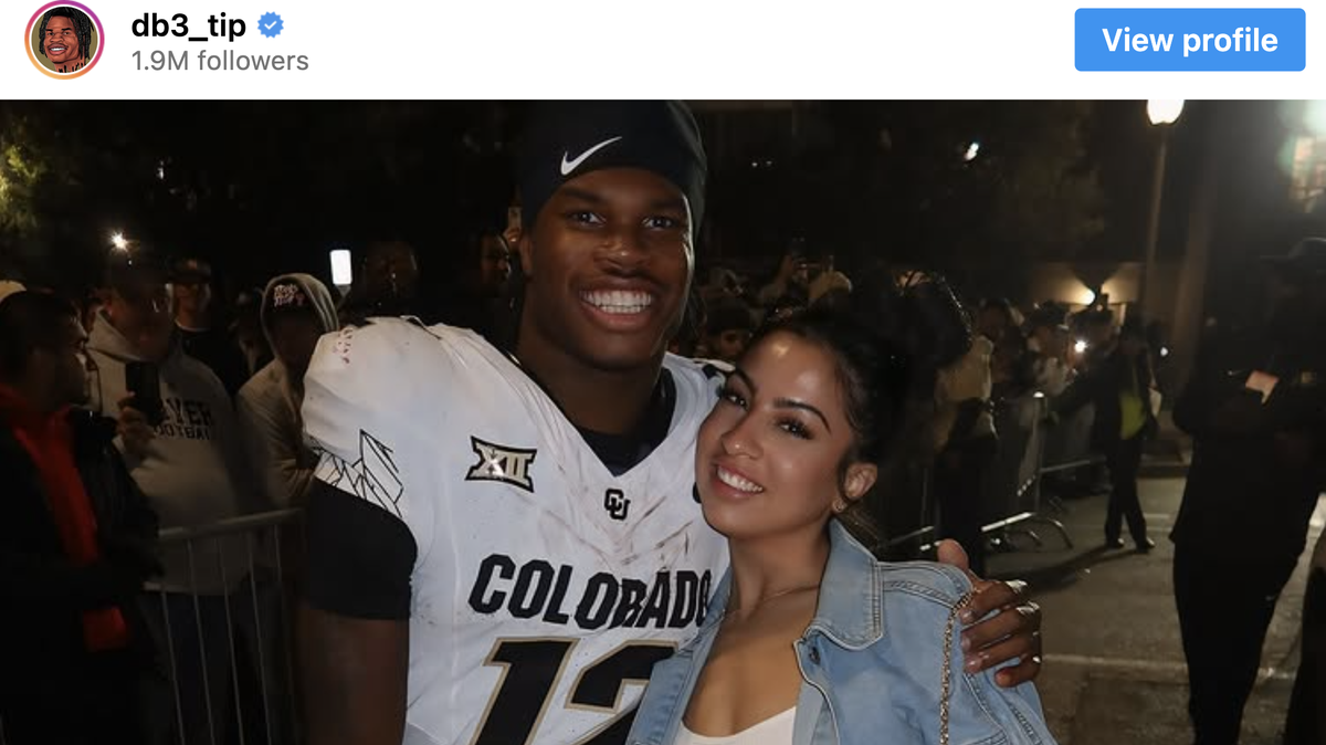 Travis Hunter with his fiancé.