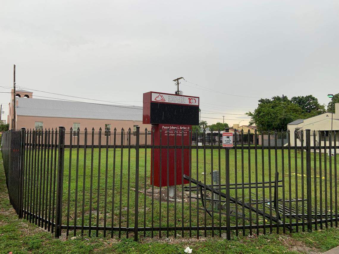 Pieces of the fence can be seen bent toward the sign of Mount Sinai Missionary Baptist Church after a BMW SUV was driven through the fence.