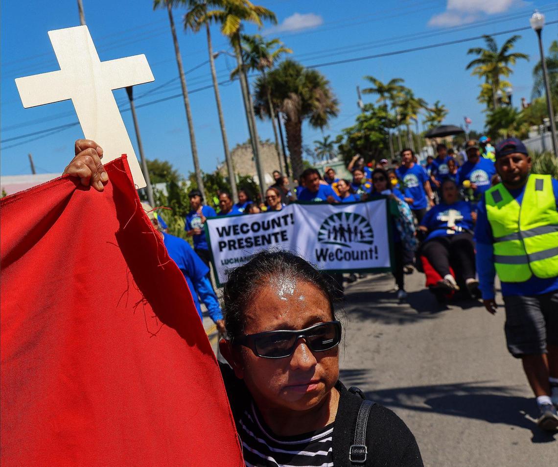 WeCount members march with crosses and roses in hand in honor of workers who have died due to extreme heat. The group walked from Sacred Heart Catholic Church in Homestead, Florida to the WeCount! option on Sunday, April 27, 2025.