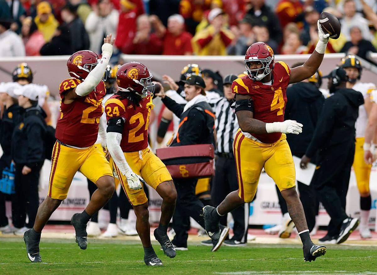 LOS ANGELES, CALIFORNIA - NOVEMBER 15: Jahkeem Stewart #4 of the Southern California Trojans celebrates his interception with Christian Pierce #24 and Desman Stephens II #23 during a 26-21 Trojans win over the Iowa Hawkeyes at Los Angeles Memorial Coliseum on November 15, 2025 in Los Angeles, California. (Photo by Harry How/Getty Images)