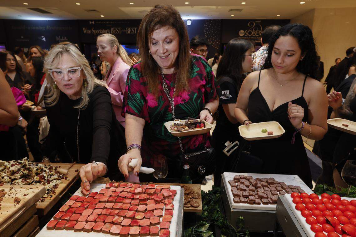 Elaine Walker, at center, selects from a sampling of desserts offered as the Fontainebleau Miami Beach presents Wine Spectator's Best of the Best with 60 of the nation’s most acclaimed chefs and more than 65 of the world’s premier wineries at the resort hotel on Friday, February 20, 2026.