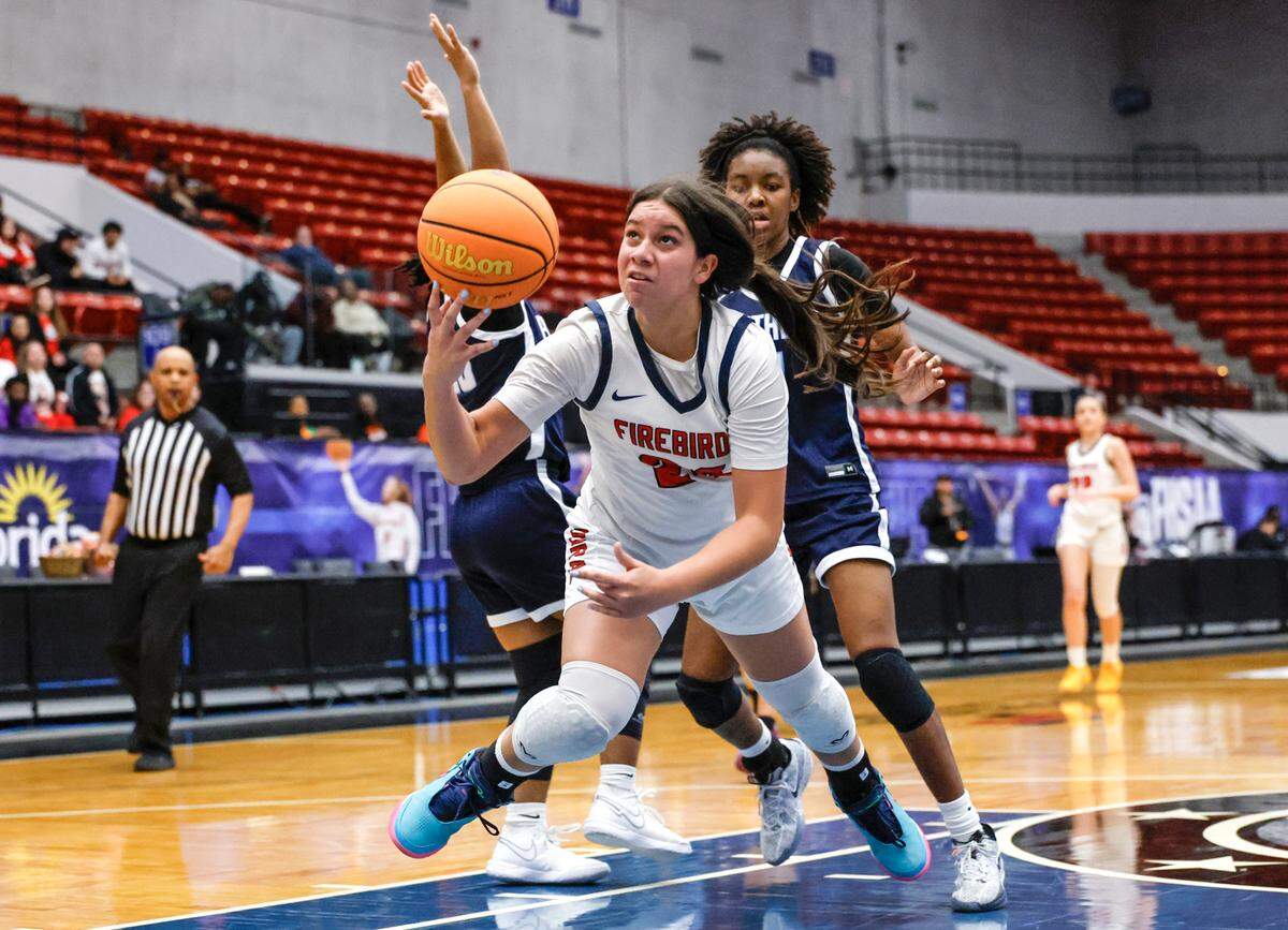 Doral Academy’s Stephanie Vega (24)drives to the basket against Dr. Phillips High School in the second half of the Class 7A semi-final for Girls High School Basketball State Championship.