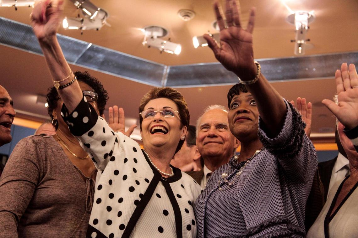 Rebeca Sosa, left, and Audrey Edmonson wave at the cameras to viewers watching at the Miami-Dade commission installation ceremony on Friday, Jan. 11, 2019. Edmonson was sworn in as chairwoman of the commission, and Sosa as vice-chairwoman.