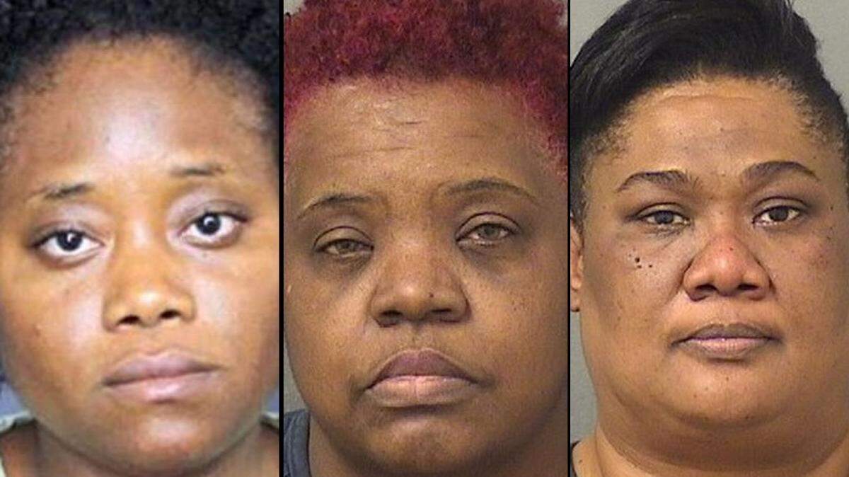 Sherlie Tesyeux, left,  Lashron Williams, center, and Phygelle Brudent were caregivers at Colonial Assisted Living facility in Boynton Beach. Police have accused them of false imprisonment and elder abuse after a 67-year-old patient with dementia was found tied to a chair with duct tape on her mouth on July 3.