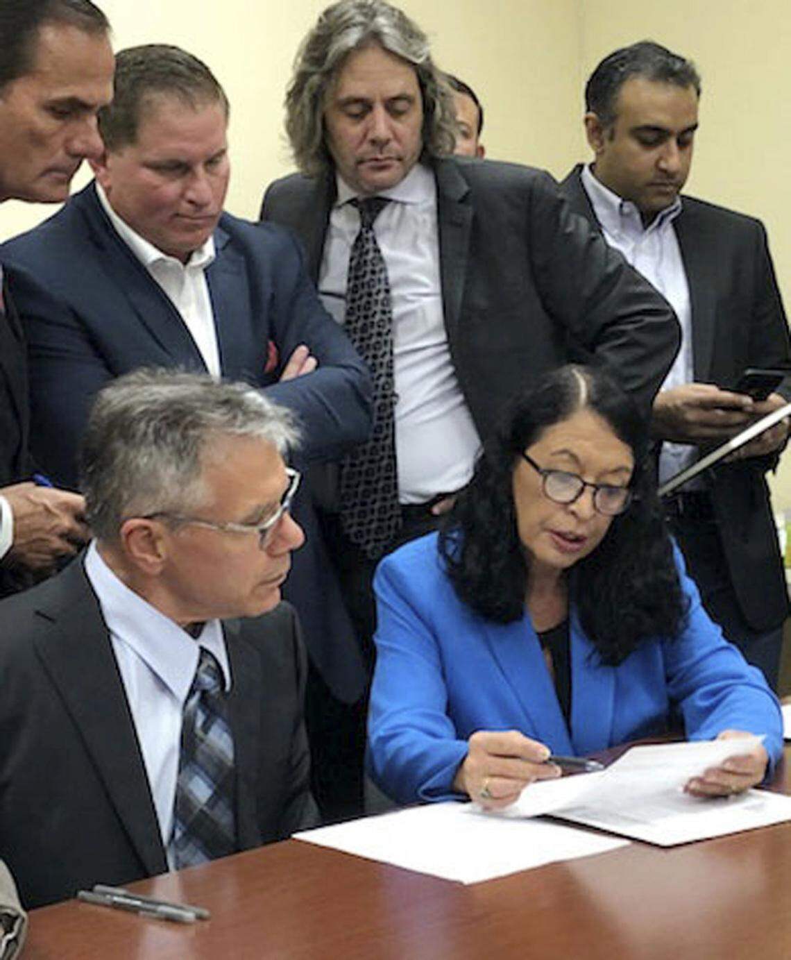 Palm Beach County Supervisor of Elections Susan Bucher, right, and Judge August Bonavita, left, look at provisional ballots in Riviera Beach.