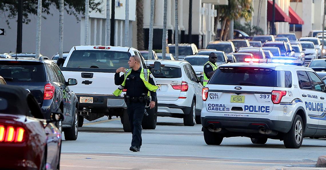 Coral Gables police officers direct traffic at the corner of Lejeune Road and Andalusia after a robbery at Regent Jewelers at 386 Miracle Mile on Thursday, December 5, 2019.