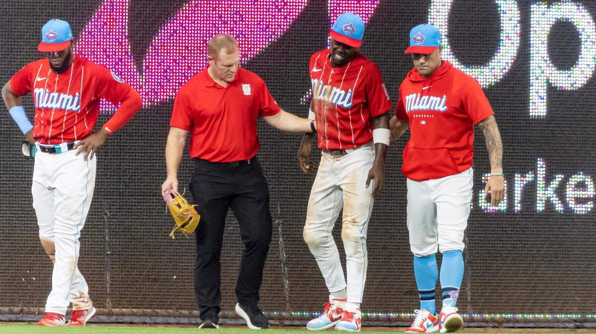 Miami Marlins center fielder Jazz Chisholm Jr. (2) reacts after hurting himself after a play against the Cincinnati Reds in the eighth inning of an MLB game at loanDepot park on Saturday, May 13, 2023, in Miami, Fla.