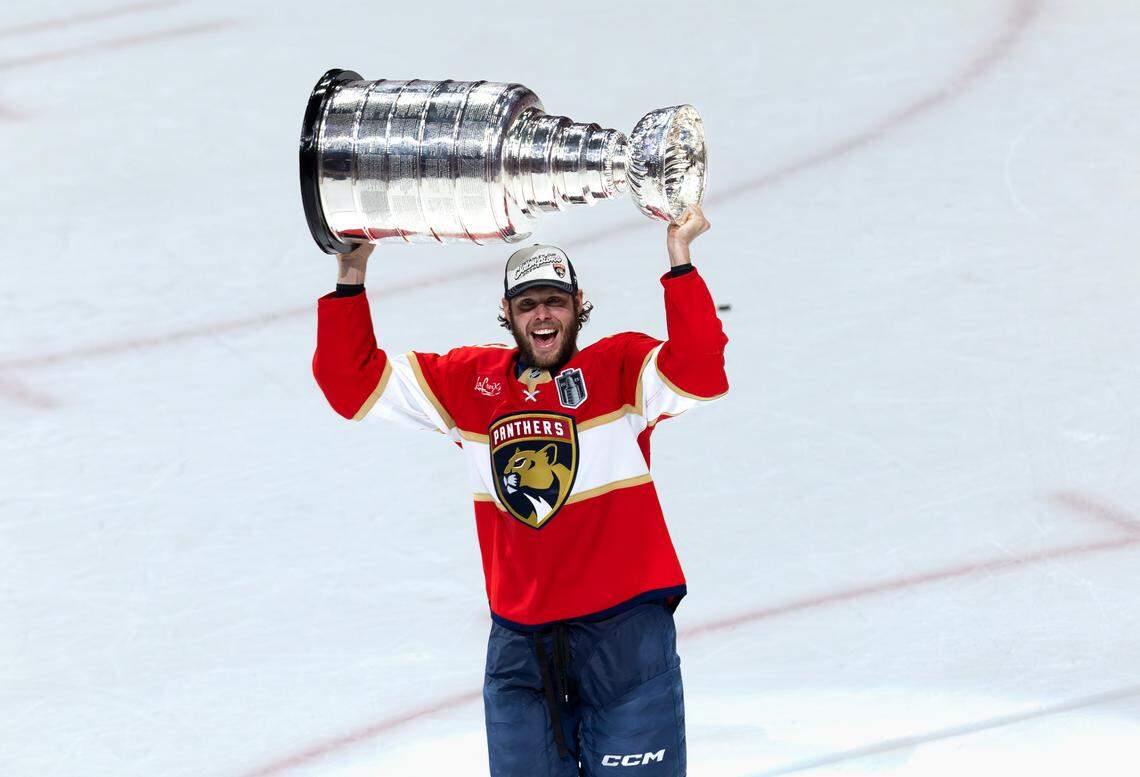 Florida Panthers center Carter Verhaeghe (23) lifts the Stanley Cup after defeating the Edmonton Oilers 5-1 in Game 6 of the Final at Amerant Bank Arena in Sunrise, Fla., on Tuesday, June 17, 2025, clinching the NHL championship.