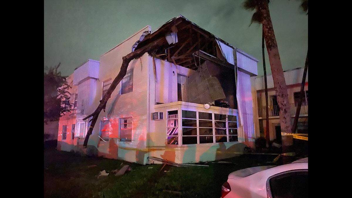 A possible tornado caused damage in the Kings’ Point area of Palm Beach County, including throwing this tree trunk into a roof.