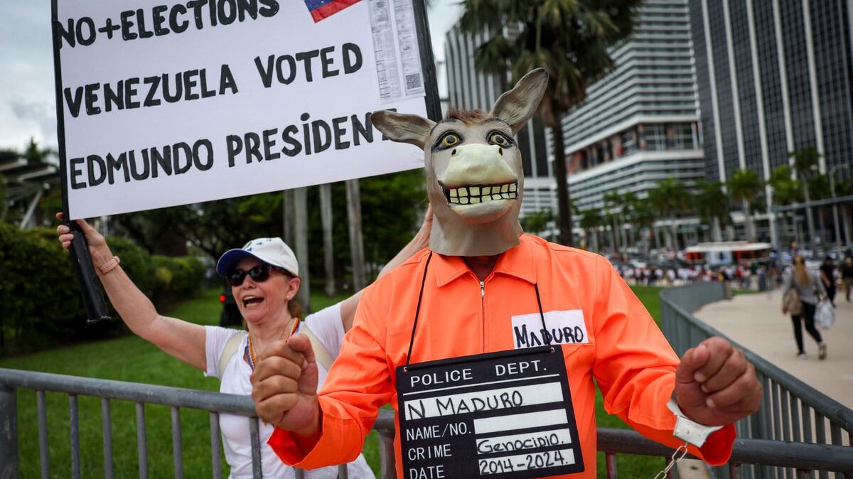 Dressed as a donkey to represent Venezuela's Nicolas Maduro, José Jimenez arrives at a rally at Miami's Bayfront Park held in opposition of what many in the international community believe was a rigged election.