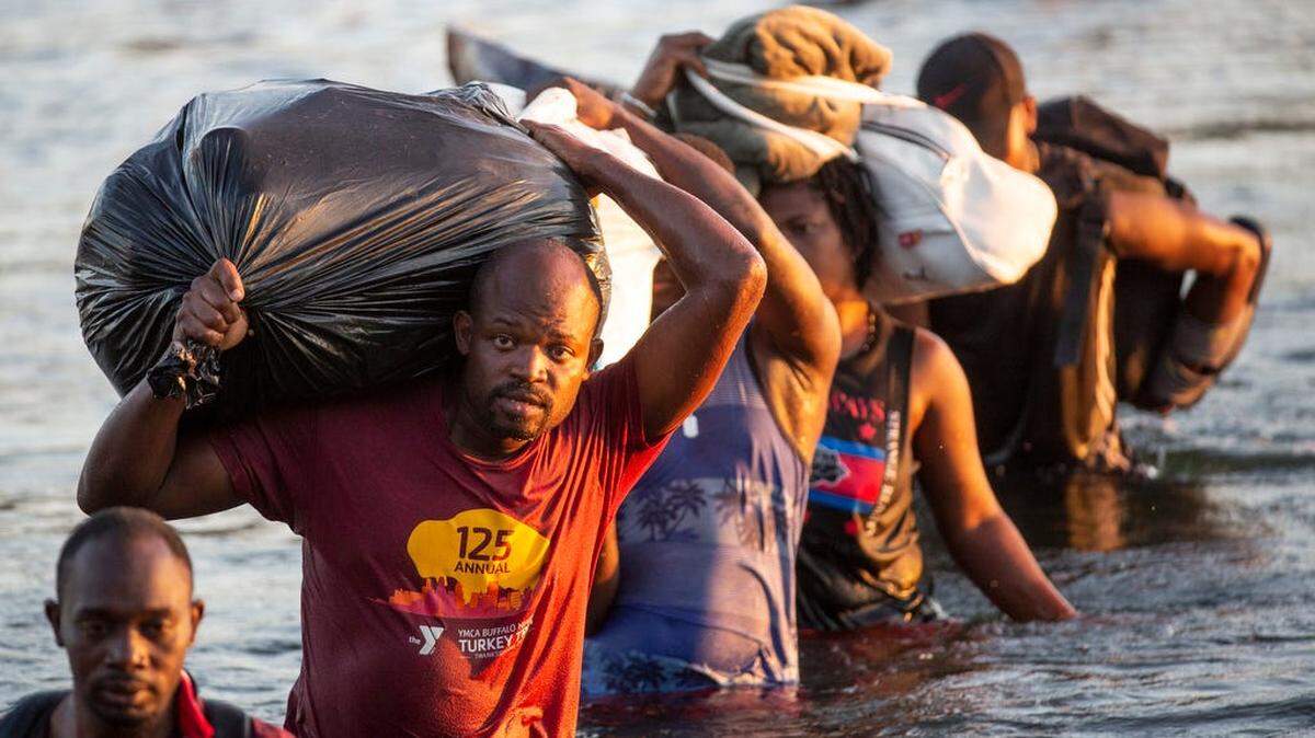 Haitian migrants, crossing the Rio Grande, driven from their home country by food insecurity and violence in 2021.