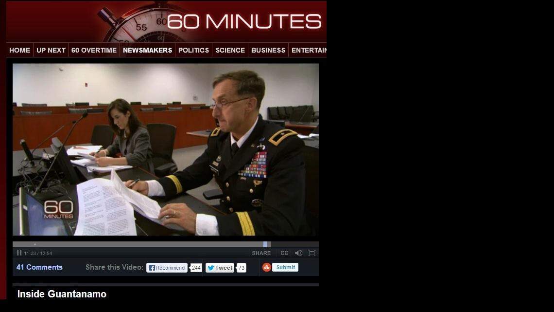 The chief Guantanamo war crimes prosecutor, Army Brig. Gen. Mark Martins, and an aide pose for a CBS crew inside the war court built for the conspiracy trial of accused 9/11 mastermind Khalid Sheik Mohammed during a September visit, in this screen grab from a "60 Minutes" episode that aired Nov. 3, 2013.