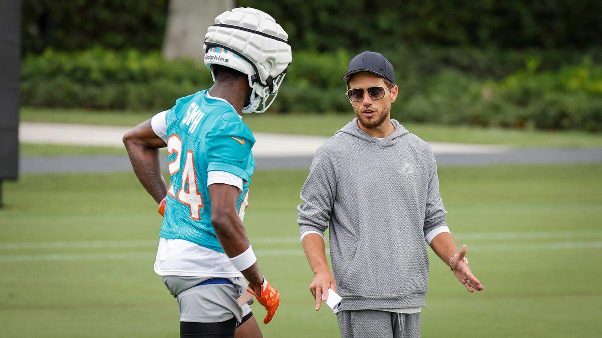 Miami Dolphins coach Mike McDaniel speaks with Miami Dolphins cornerback Cam Smith (24) during practice at Baptist Health Training Complex in Miami Gardens, Florida, on Wednesday, July 24, 2024.