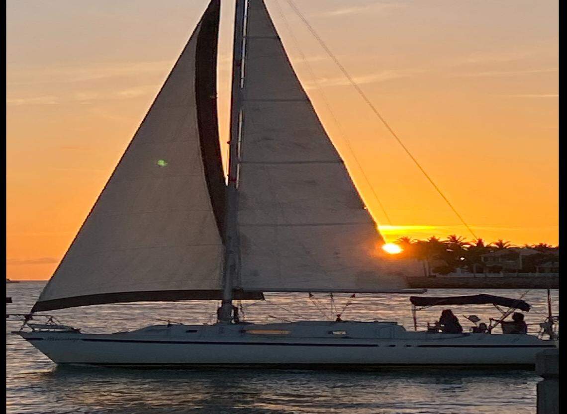 A sailboat passes by Malory Square at sunset Wednesday, March 31, 2021.