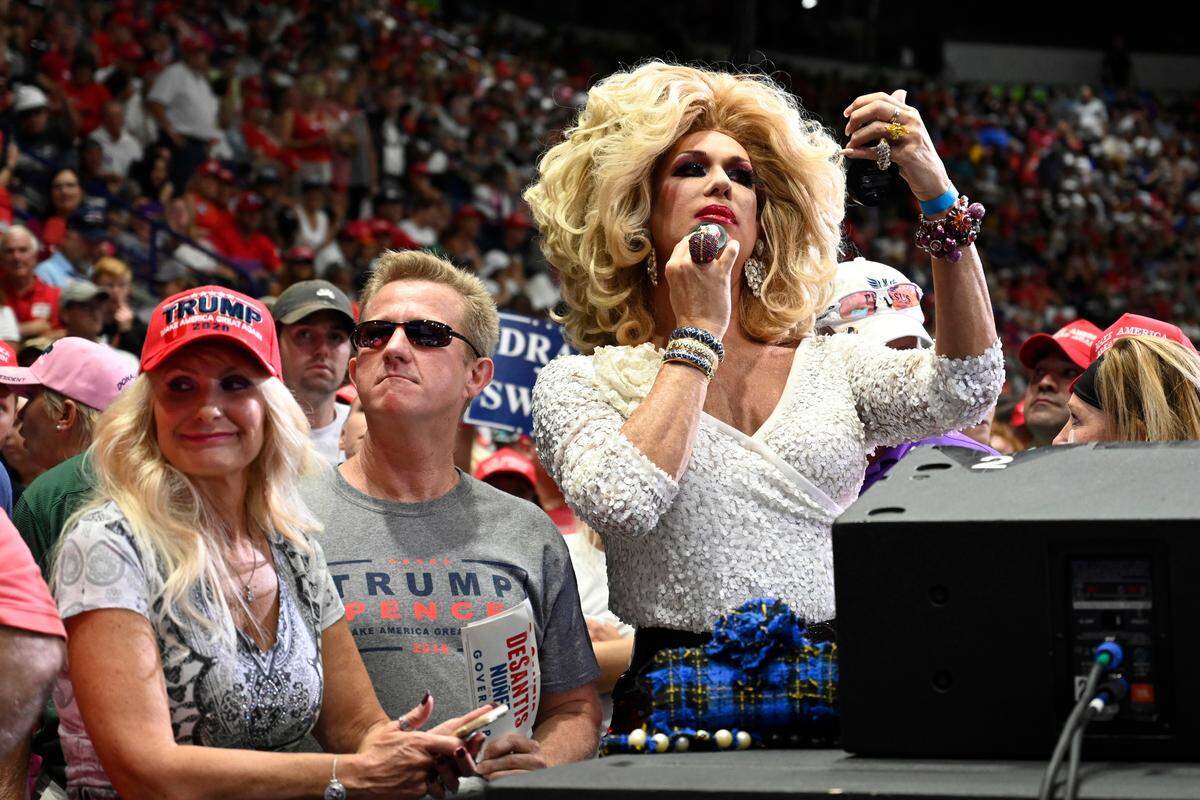 Conservative drag diva Elaine Lancaster of Miami, right, waits for President Donald Trump to speak at a rally in Estero, Fla., Wednesday, Oct. 31, 2018. Trump is campaigning for Florida Republican Gov. Rick Scott, who is challenging incumbent Democratic Sen. Bill Nelson for a seat in the Senate.