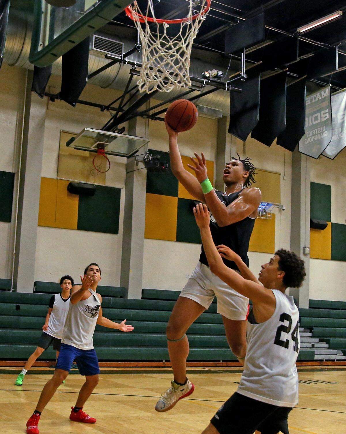 Mater Academy basketball player Malik Reneau (5) goes to the basket during practice alongside teammates at Mater Academy on Wednesday, November 13, 2019 in Hialeah Gardens.